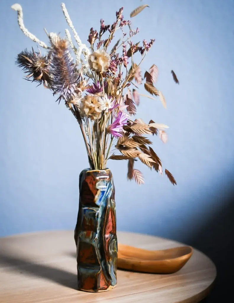 Close-up of a warm-toned ceramic piece, capturing the "fabric of being" through tactile clay surfaces and mindful craftsmanship.